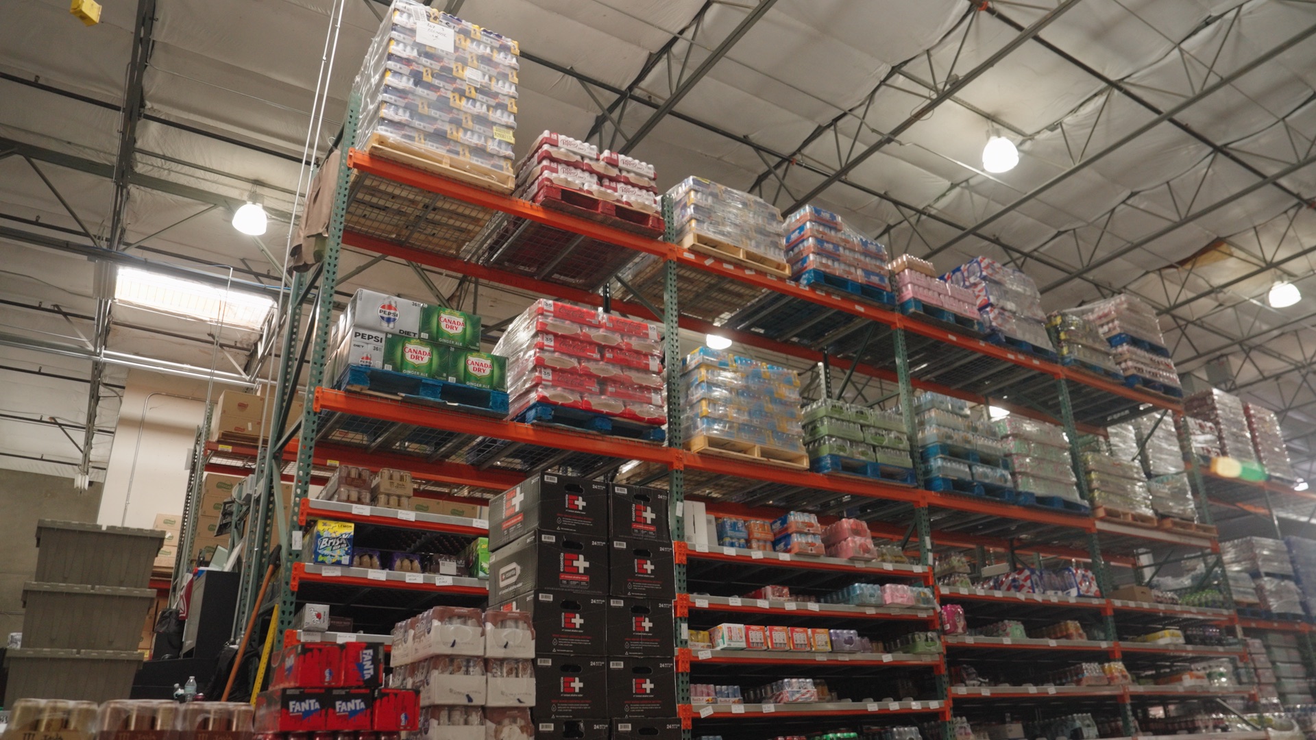 Warehouse racking stacked to the ceiling with snacks and drinks ready for route delivery